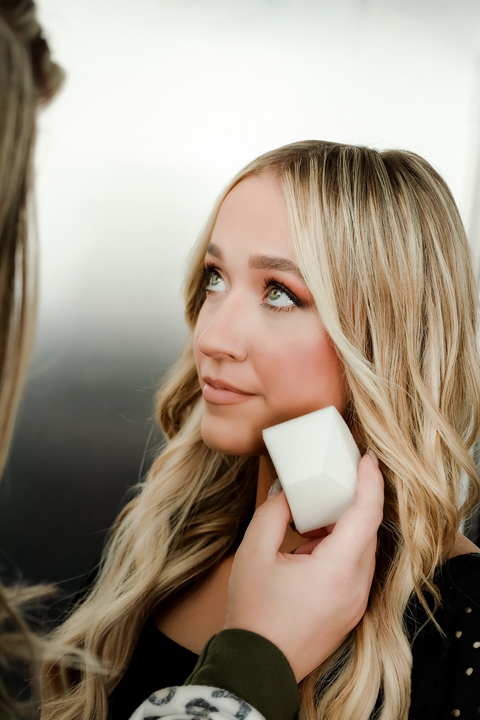 A lady using makeup sponge