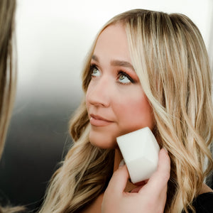 A lady using makeup sponge