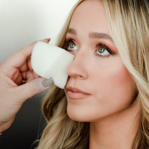 A lady using makeup sponge