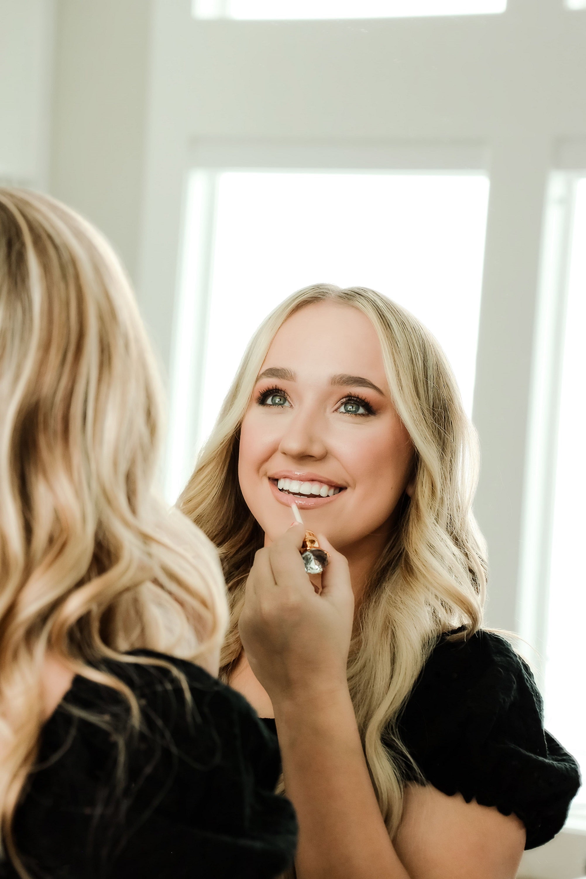 A lady applying Lip Gloss